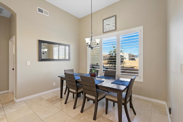 dining room featuring light tile patterned floors and a chandelier