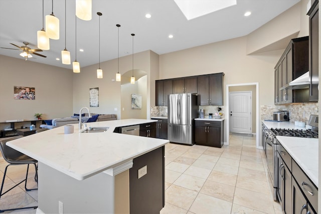 kitchen with a spacious island, stainless steel appliances, a sink, and open floor plan