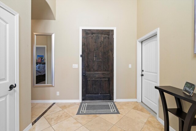 foyer entrance with light tile patterned flooring