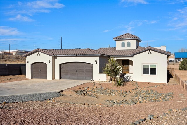 mediterranean / spanish house with a garage