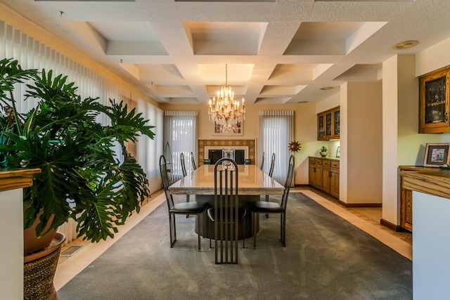 carpeted dining room featuring coffered ceiling, a chandelier, and beam ceiling