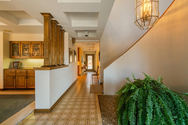 corridor with an inviting chandelier