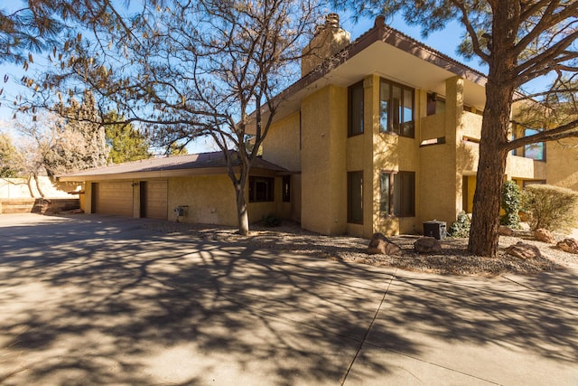 view of home's exterior featuring a garage and central AC