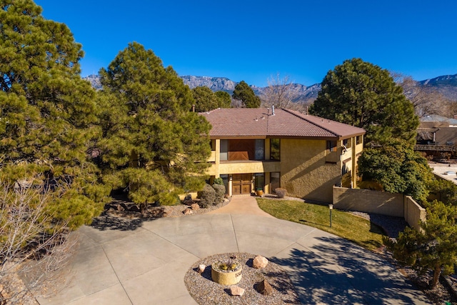 view of front of home featuring a balcony and a mountain view