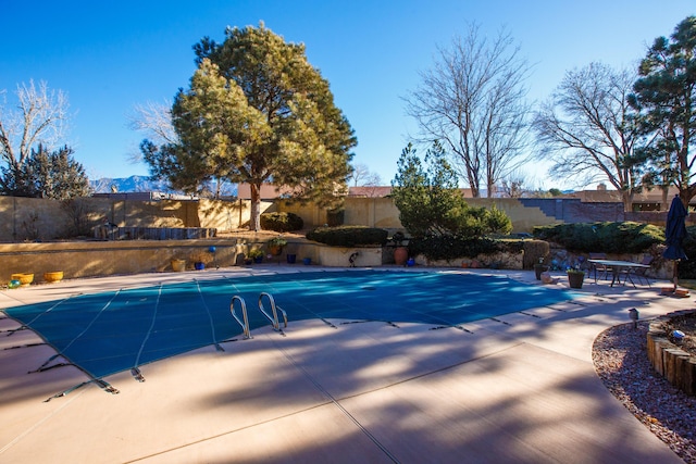 view of swimming pool featuring a mountain view and a patio