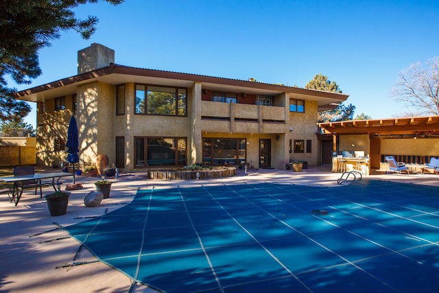 view of pool with a pergola and a patio area