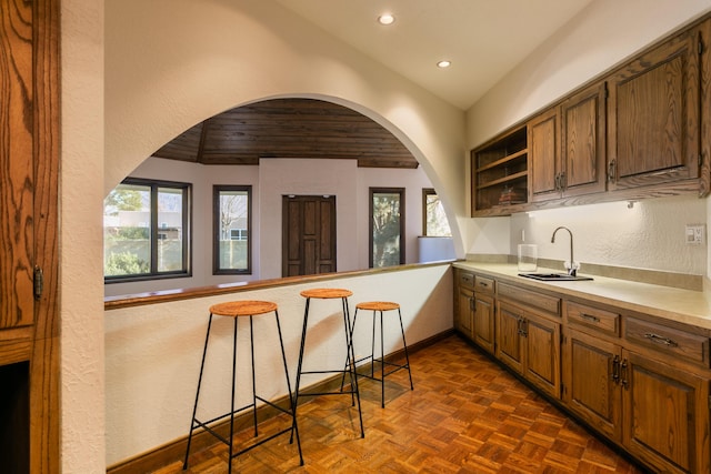 kitchen featuring wood ceiling, dark parquet flooring, and sink