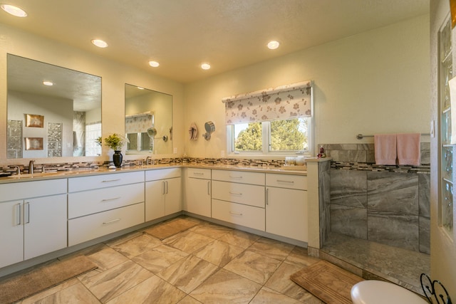 bathroom featuring vanity, backsplash, and a shower