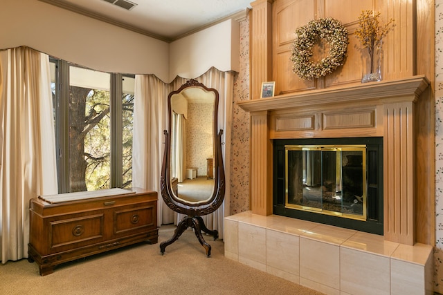 sitting room featuring light carpet, crown molding, a fireplace, and a healthy amount of sunlight