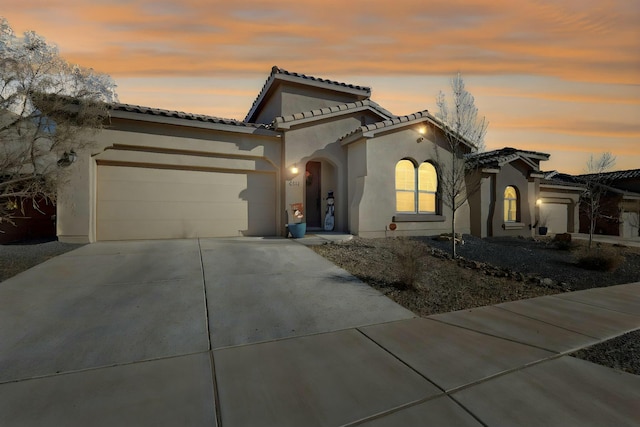 mediterranean / spanish home featuring a garage