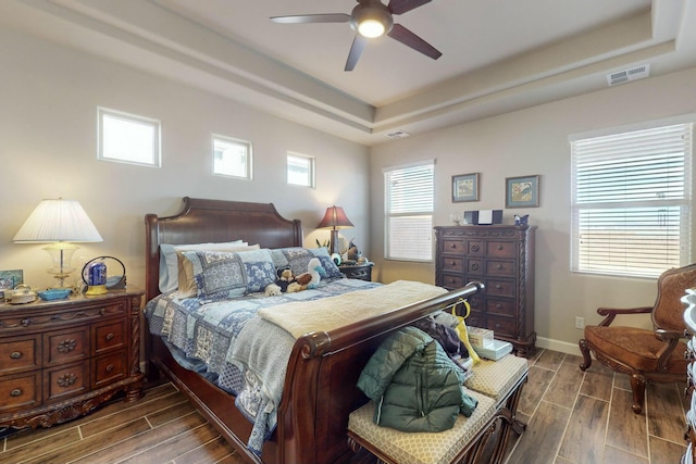 bedroom featuring ceiling fan and a raised ceiling