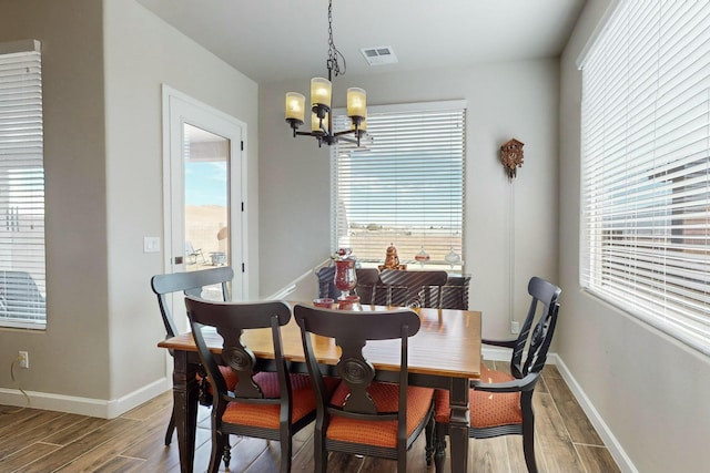 dining space with a chandelier and hardwood / wood-style flooring