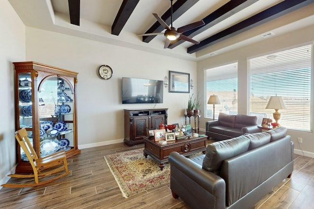 living room featuring ceiling fan and beam ceiling