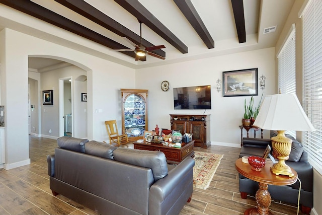 living room featuring ceiling fan and beam ceiling