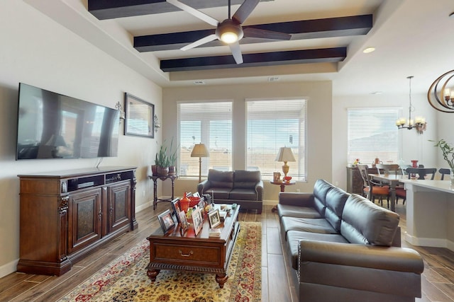 living room featuring ceiling fan with notable chandelier and beamed ceiling