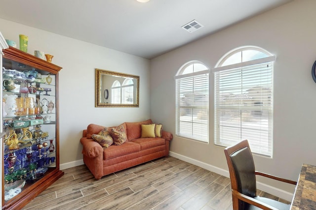 office with light hardwood / wood-style flooring and plenty of natural light