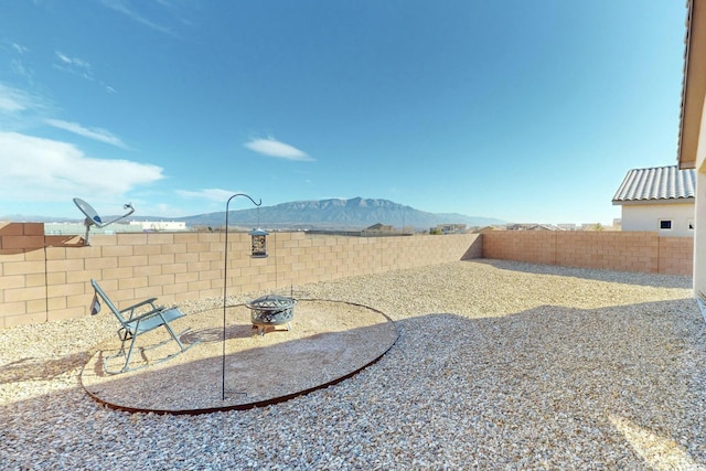 view of yard with a mountain view and a fire pit