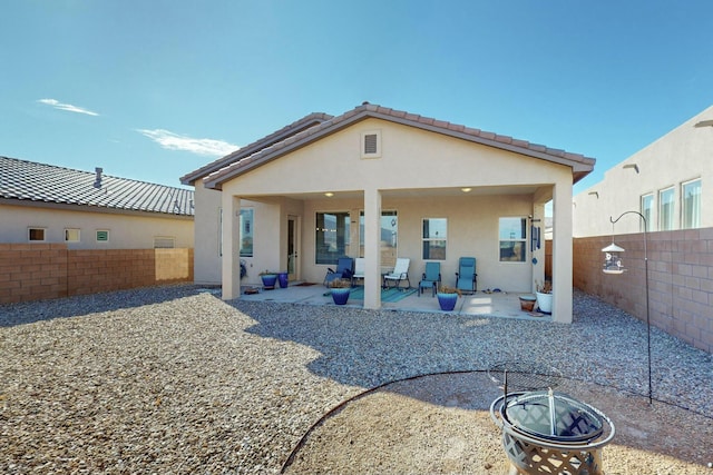 back of house with a patio