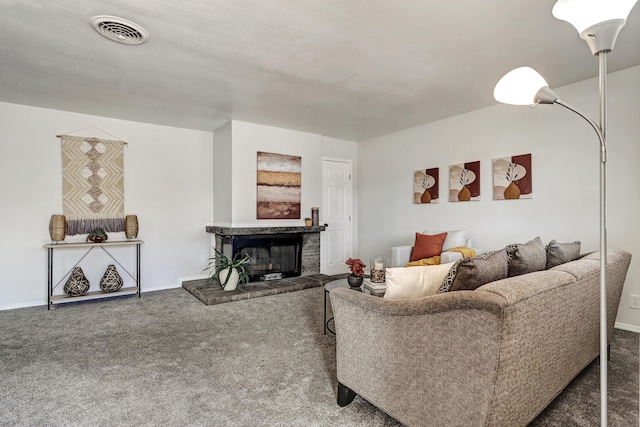 living area with a fireplace, carpet flooring, and visible vents