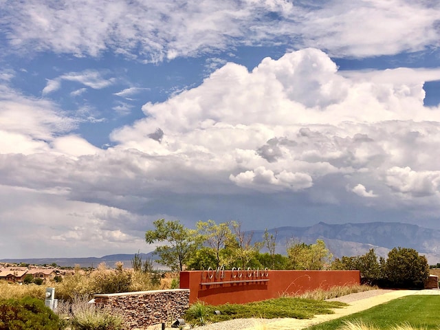 community / neighborhood sign with a mountain view