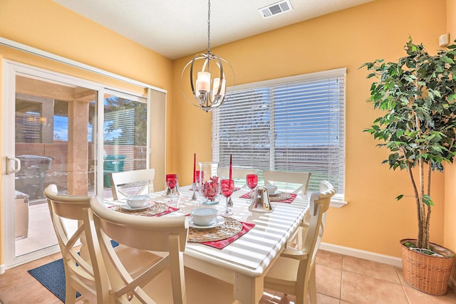 dining room featuring light tile patterned floors, baseboards, visible vents, and a chandelier