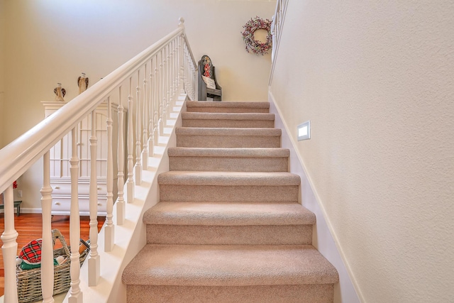 staircase featuring wood finished floors