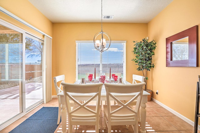 dining room with visible vents, a notable chandelier, a textured ceiling, light tile patterned floors, and baseboards