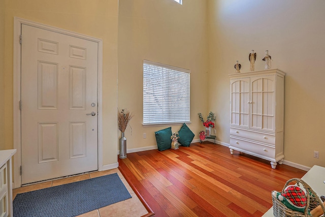 foyer entrance featuring wood finished floors and baseboards