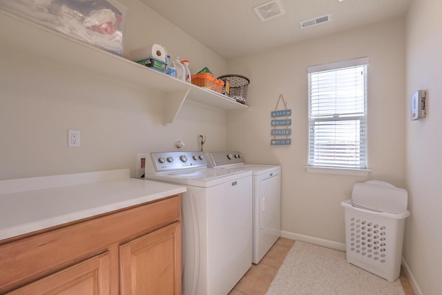 clothes washing area featuring independent washer and dryer, light tile patterned floors, baseboards, and visible vents