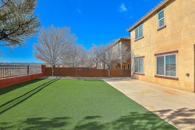 view of yard featuring a patio and a fenced backyard