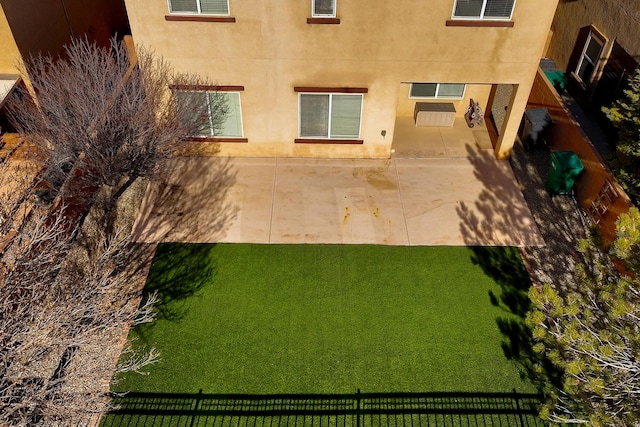 exterior space featuring stucco siding and fence