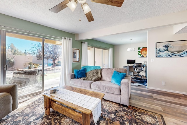 living room with a textured ceiling and hardwood / wood-style floors