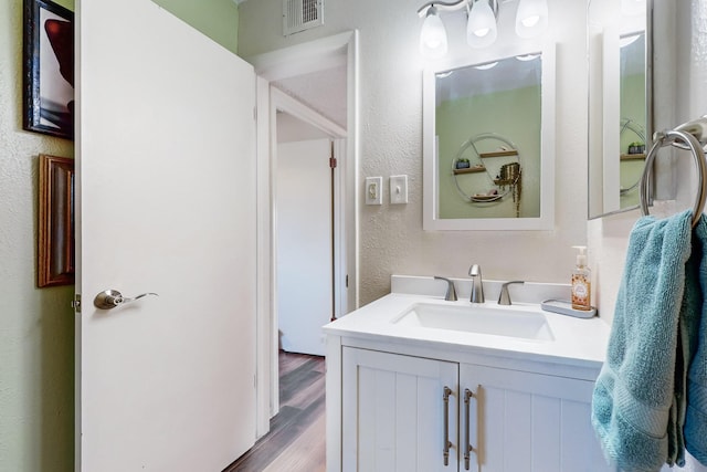 bathroom featuring hardwood / wood-style floors and vanity