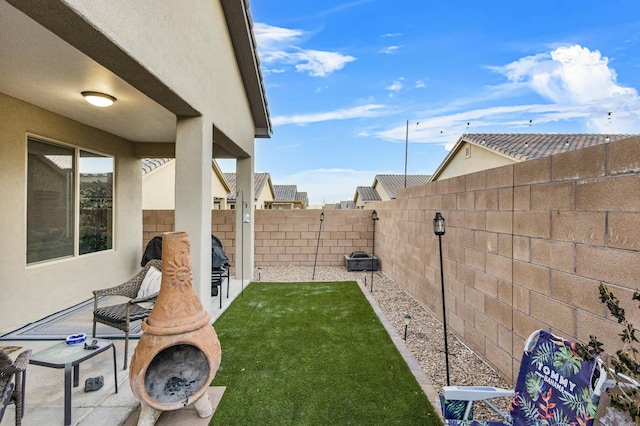 view of yard featuring a patio area and a fenced backyard