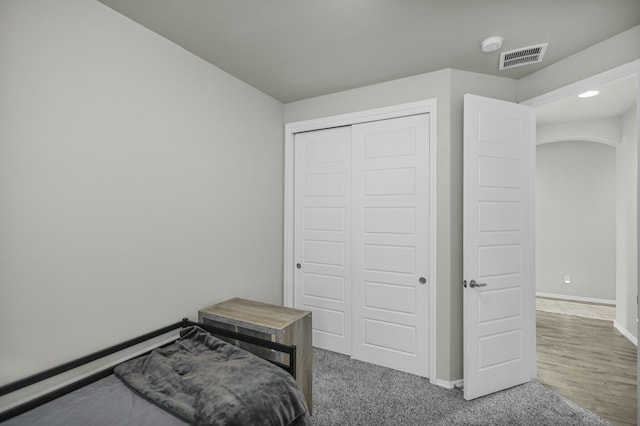 carpeted bedroom with a closet