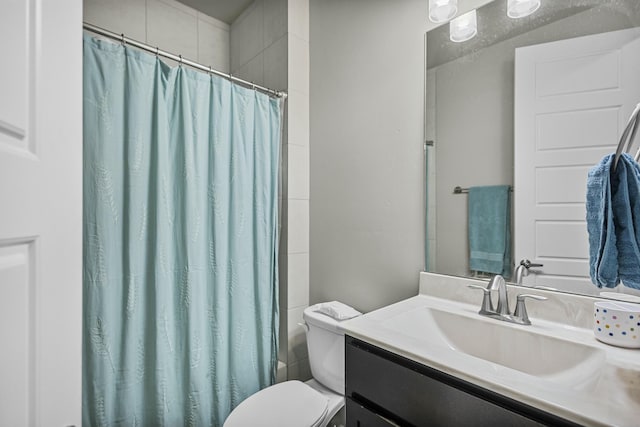 bathroom featuring toilet and vanity