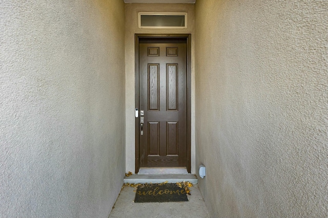 doorway to property with stucco siding