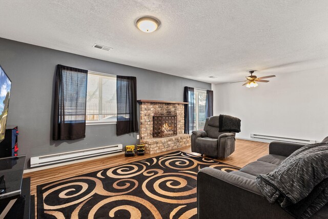 living room with dark hardwood / wood-style flooring, a textured ceiling, and a baseboard radiator