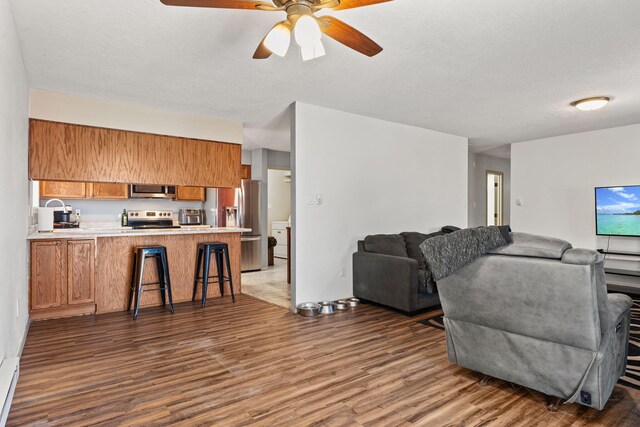 kitchen with a textured ceiling, black dishwasher, stainless steel fridge, ceiling fan, and light tile patterned floors