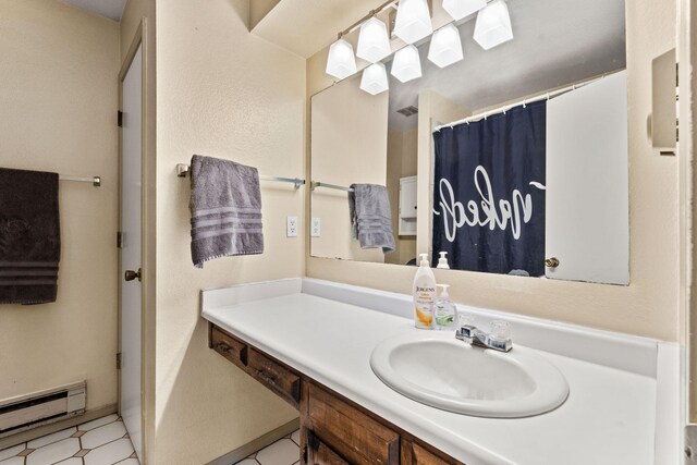 carpeted bedroom with a textured ceiling, ceiling fan, connected bathroom, and a baseboard radiator