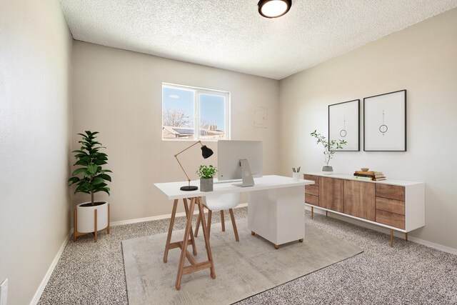 carpeted home office with a textured ceiling