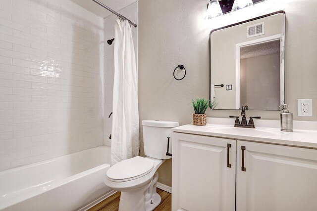 full bathroom featuring toilet, vanity, shower / tub combo with curtain, and hardwood / wood-style floors