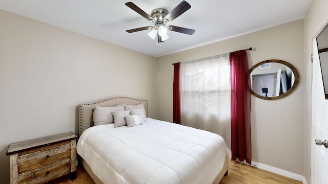 bedroom with ceiling fan and light wood-type flooring