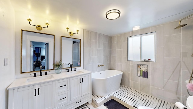 bathroom with tile patterned floors, vanity, and separate shower and tub