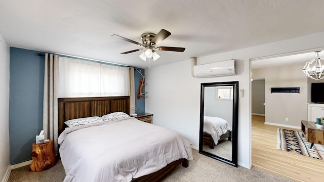 bedroom featuring light colored carpet, ceiling fan with notable chandelier, an AC wall unit, and multiple windows