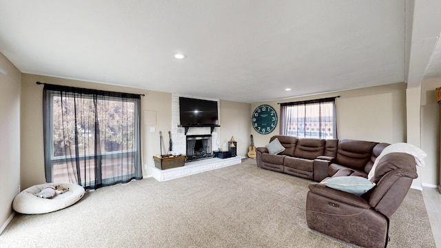 carpeted living room with a fireplace