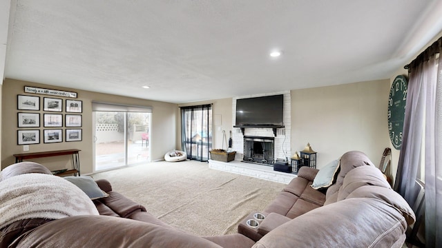 living room featuring a brick fireplace and carpet flooring