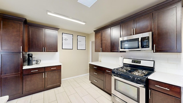 kitchen with appliances with stainless steel finishes and dark brown cabinetry