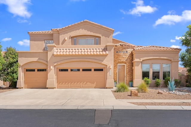 mediterranean / spanish home featuring a garage