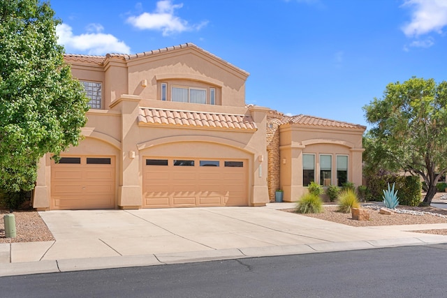 mediterranean / spanish-style home with a garage